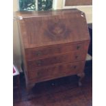 A 20th Century walnut veneered bureau, the fall front enclosing a fitted interior, drawers below