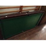 A 20th Century folding snooker table, small sized, green baized top