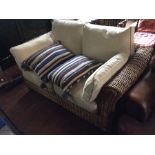 A contemporary Marks and Spencers wicker framed two seater settee, with removable cushions and extra