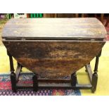 An early 18th Century oak gateleg table, fitted with a single drawer, raised on turned legs