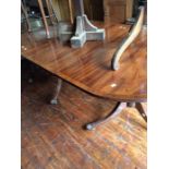 A late 19th or Early 20th Century Mahogany pedestal dining table on brass castors.