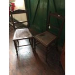 A Pair of Victorian Oak Chairs with cane work seats on turned supports.