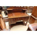 A mid Victorian mahogany dressing table, fitted with an upper shelf section, four short drawers