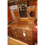 An Edwardian beech dressing chest, having a mirrored back and two small drawers, the base section