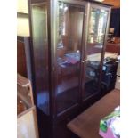 A Modern Mahogany Stag Display Cabinet fitted with two doors.