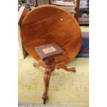 A Victorian style mahogany tilt-top breakfast table, the top of circular form raised on a pedestal