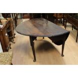 A George II oak drop leaf dining table, c.1730 altered and restored