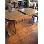 A 1970s teak sideboard, together with a teak extending table with a removable leaf (2)