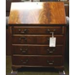 A George III style mahogany bureau, of large size, the fall front enclosing a fitted interior,