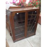 An Art Deco oak two door glazed display cabinet