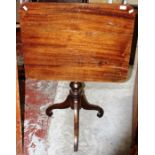 An early 19th Century mahogany tilt-top tripod table, the top of rectangular form, raised on a