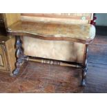 A mid Victorian walnut quarter veneered side table, of serpentine form, shaped supports, united by a