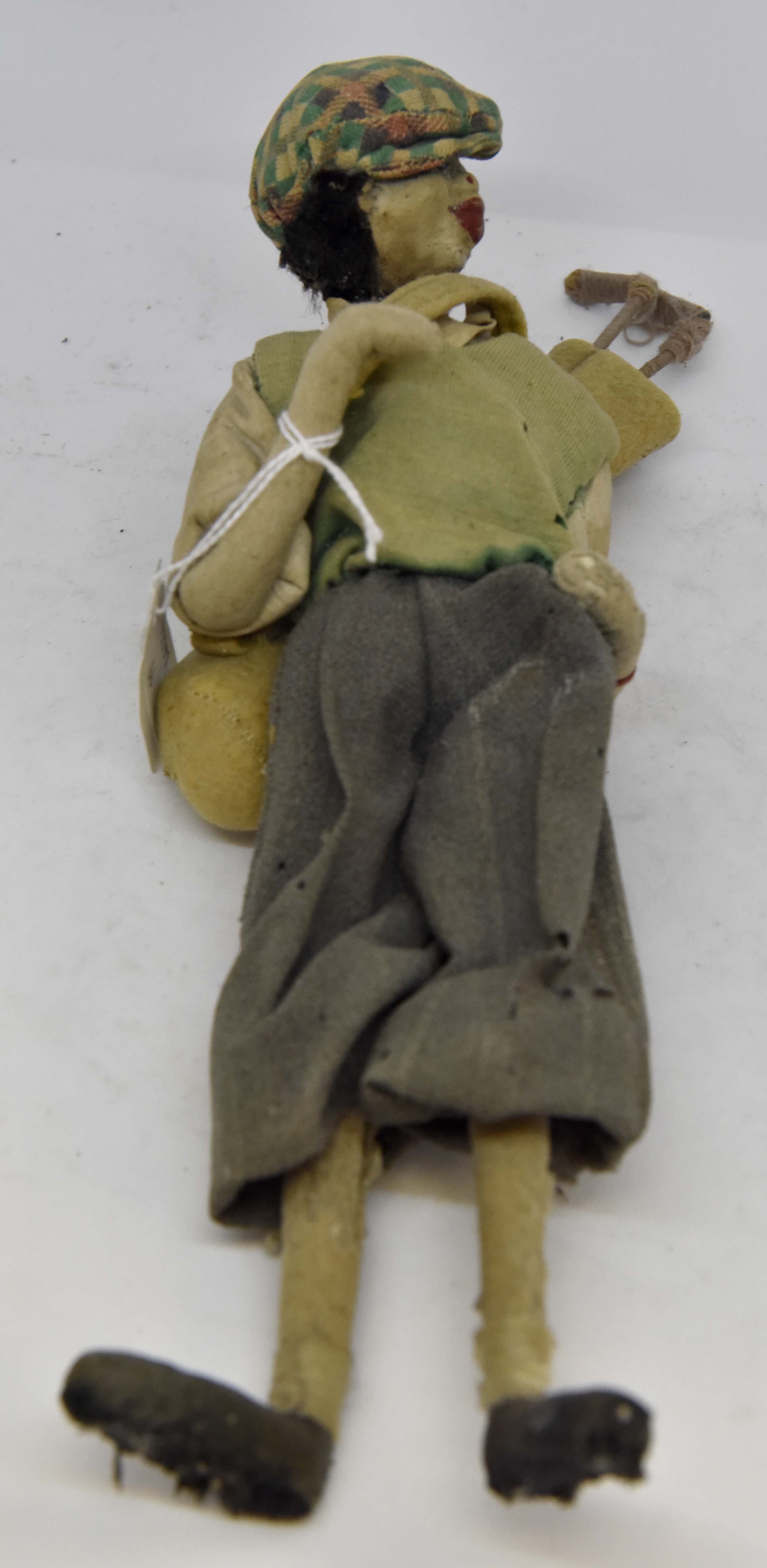 A Guppi Golfer doll,