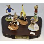 Five Royal Doulton boxed Bunnykins games statues with display stand, swimmer, soccer, gymnast,