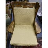 A Rupert Griffins Oak Armchair, yellow fabric cushions.