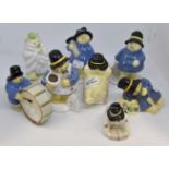 A group of eight late 20th Century Coalport Paddington Bear Statues including Paddington Bakes a