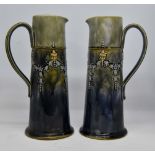 Pair of late 19th Century Royal Doulton tall slim jugs with swag detail,