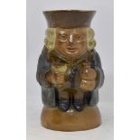 Doulton Lambeth seated Toby jug raised on a domed base with flask and goblet,