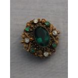 A yellow metal, diamond, emerald oval brooch, set central ovoid green paste, the wide filigree