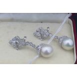 A pair of 18ct white gold, diamond and South Sea pearl drop earrings, having open work mount in