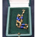 An 18ct. yellow gold blue enamel bracelet ,formed from alternating links of gold mounted deep blue