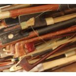 A collection of violin bows