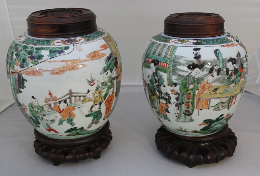 A pair of Chinese Kangxi style ginger jars retaining original hardwood stands and tops with shou