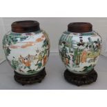 A pair of Chinese Kangxi style ginger jars retaining original hardwood stands and tops with shou