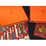 Five boxed vintage Hermes silk scarves, all 90cm x 90cm, to include; A Hermes "Fleurs de Lotus" silk