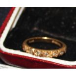 An 18ct. gold and diamond half eternity ring, having engraved half hoop set seven round cut