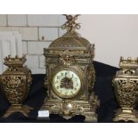 A 19th century gilt brass clock garniture, gong strike, with circular white enamel Arabic numeral