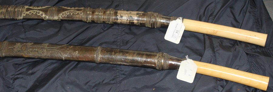 Two 19th century Burmese sword Dha, each having slightly curved single edge blade swollen to tip,