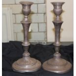 A pair of silver plated candlesticks, each with gadrooned detachable nozzle, wrythen ribbed sconce