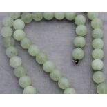 A jade style bead necklace, each bead appriox. 12mm diameter, with yellow metal clasp, length 60.