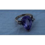 A 14ct. yellow gold, diamond and amethyst ring, set large pendeloque cut amethyst to centre and