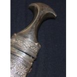 An Omani Khanjar, early 20th century, of traditional form, having shaped white metal mounted horn