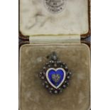 A fine diamond and enamel heart pendant brooch, fashioned from white and yellow metal, having