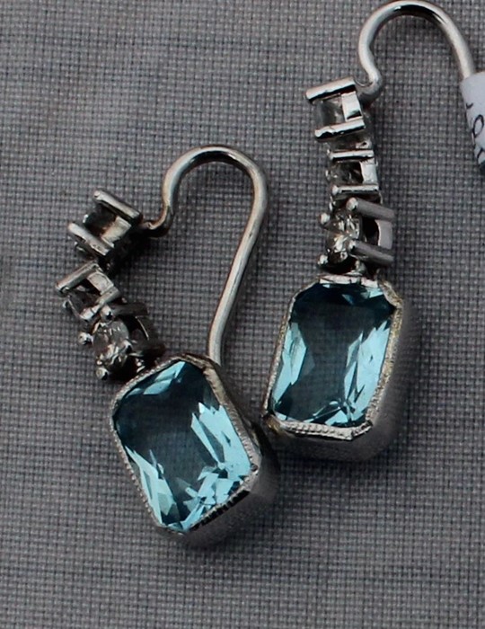 A pair of precious white metal, diamond and aquamarine drop earrings, each having three links claw