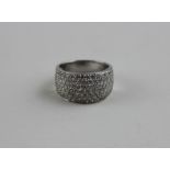 **TO BE COLLECTED**An 18ct. white gold and diamond dress ring, pave set numerous diamonds, (total