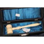 A turned ivory gavel, of traditional form, engraved and gilded with inscription "Presented to