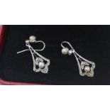 A pair of Edwardian precious white metal, pearl and diamond earrings, each having single seed