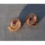 A pair of yellow metal and ruby "amonite" earrings, each fashioned as an amonite and set round cut