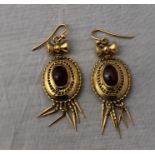 A pair of Victorian precious yellow metal and garnet set drop earrings, of domed ovoid form with