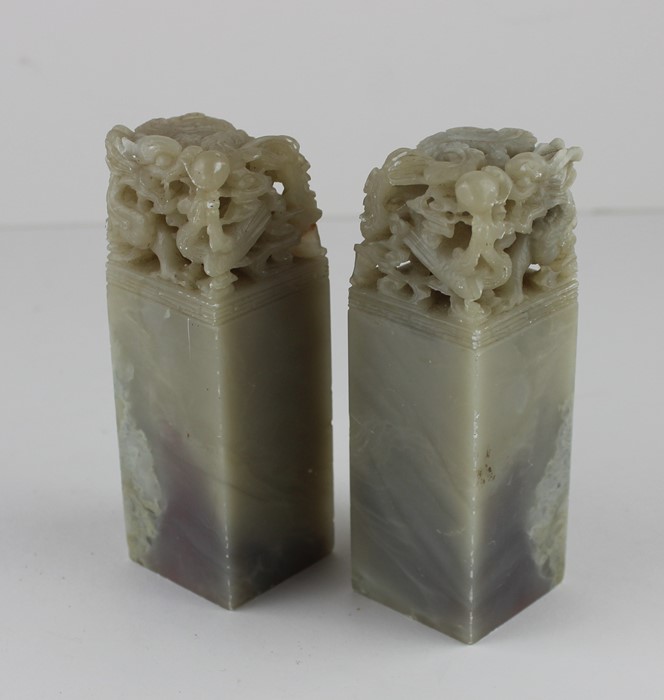 Two Chinese soapstone seals, of square form, the tops pierced and carved with scaled dragon,
