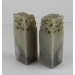 Two Chinese soapstone seals, of square form, the tops pierced and carved with scaled dragon,