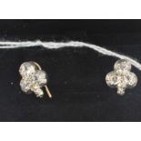 A pair of white metal and diamond clover shaped earrings, each mount fashioned as a three leaf