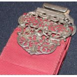 A late Victorian silver nurse's buckle, by Walter Raymond, assayed London 1896, each half cast,