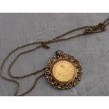 A 1982 1/10th Krugerrand gold coin, within 9ct. gold pendant mount with scrolling filigree border,