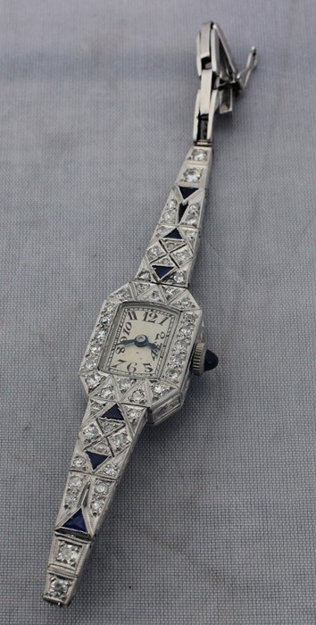 An Art Deco style platinum, diamond and sapphire set cocktail watch, manual movement, having