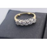 An 18ct. gold five stone diamond ring, set row of five round brilliant cut diamonds, (total